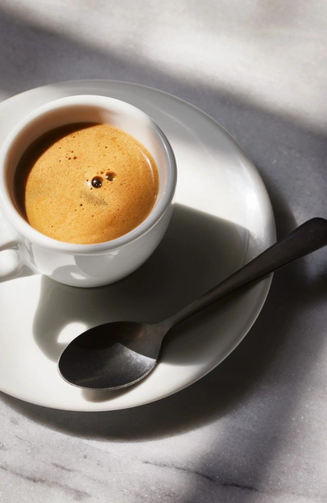 Espresso in a white cup on marble