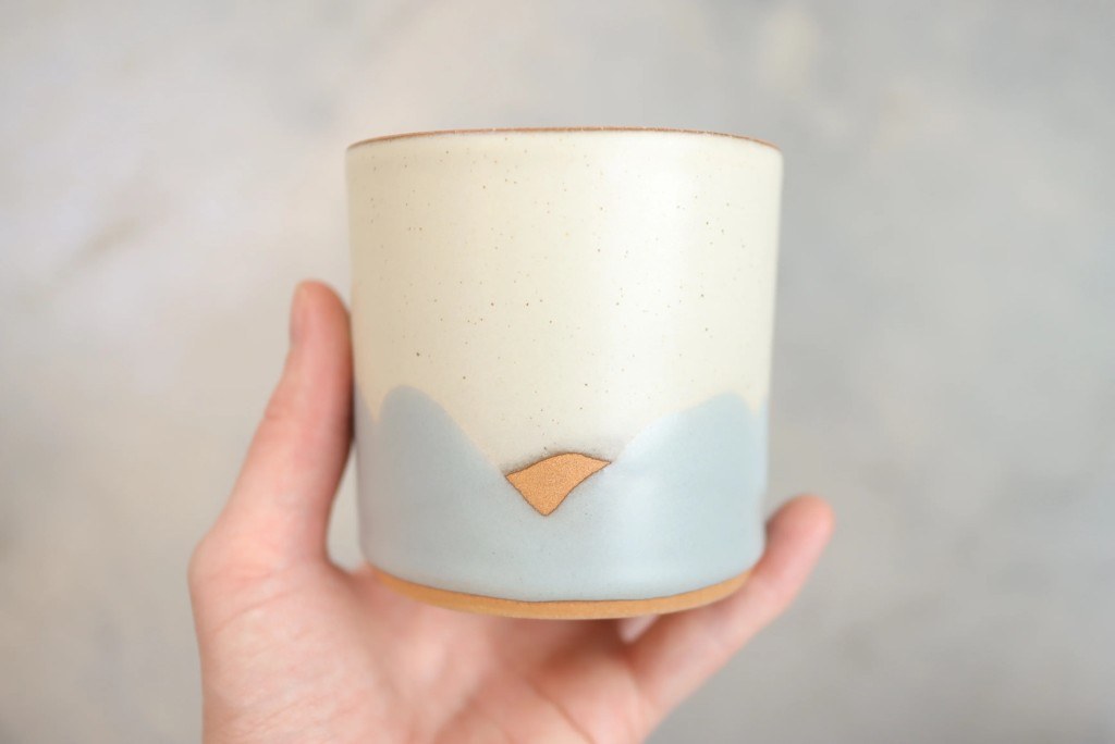 Cream and blue-gray Sven cup held in hand