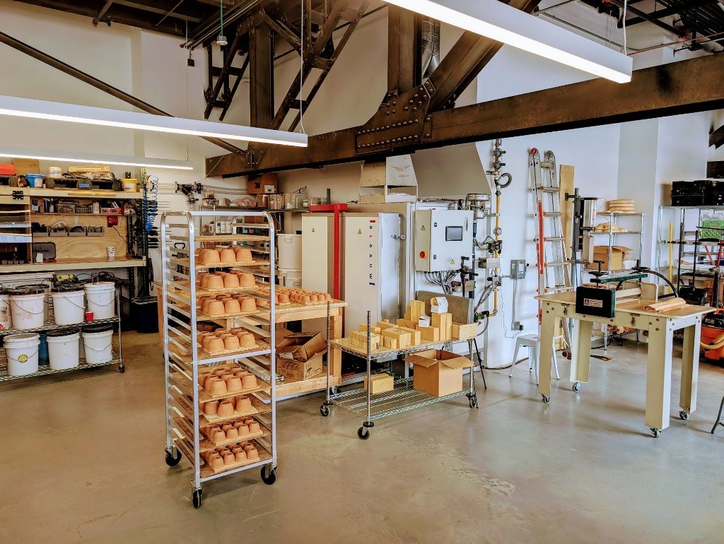 Sven Ceramics studio with racks of pottery